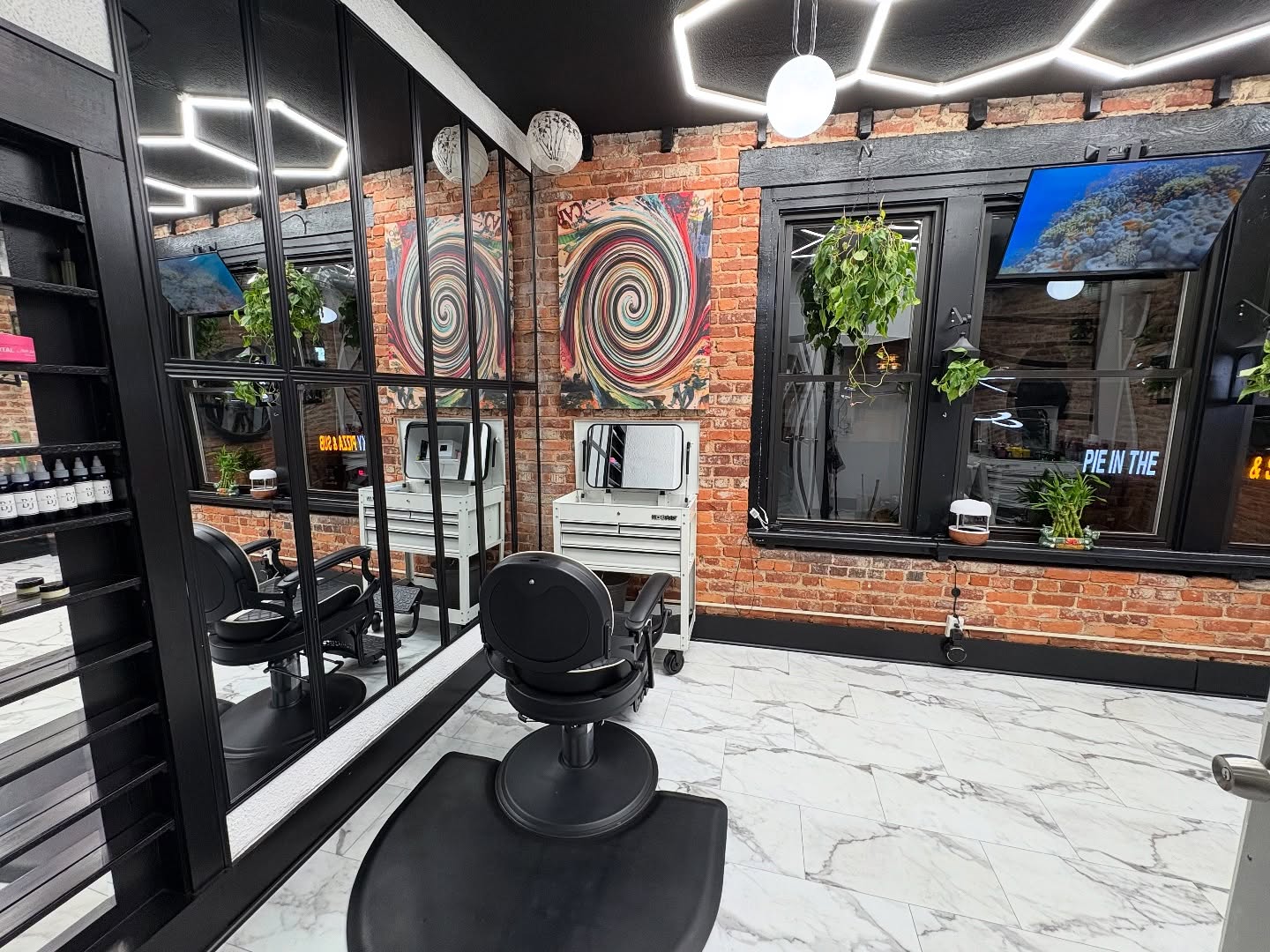 Chopaholix interior — brick wall, marble floor, hex LED lighting